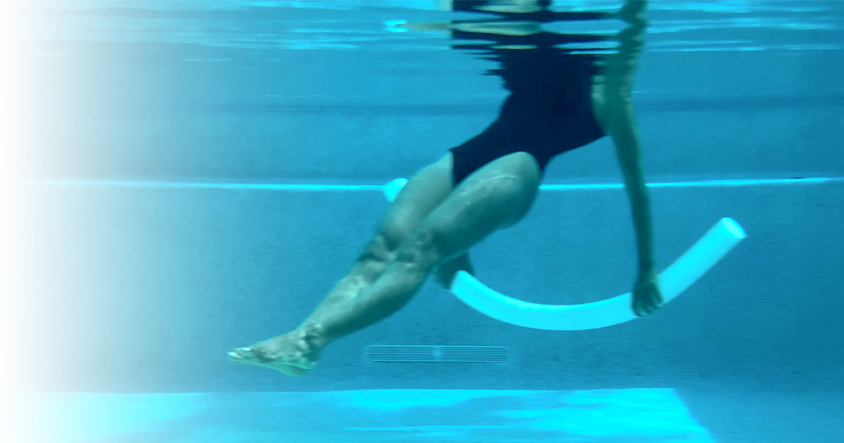 Woman performing Water Pilates exercise in a pool using a noodle for core strength and balance