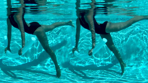 Woman alternating leg lifts in a pool pilates swimming exercise with a noodle.