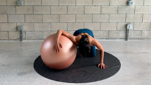 Chest stretch on Swiss ball for posture correction exercises