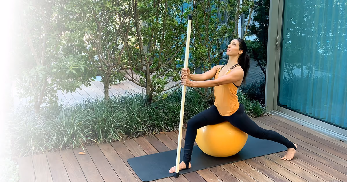 Posture correction exercises using Swiss ball and stick for full-body alignment