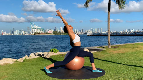 Hip flexor stretch with overhead reach on a stability ball