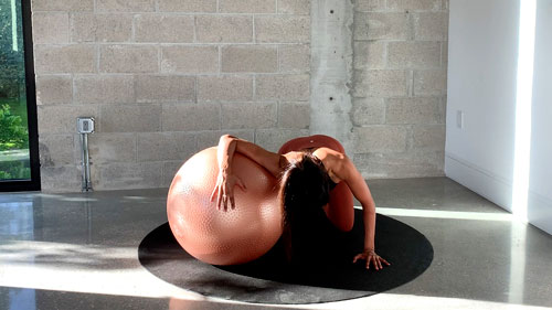 Kneeling chest stretch with a stability ball to open shoulders and improve posture