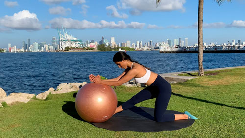 Hamstring stretch with a stability ball from a kneeling position with front leg extended