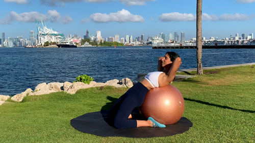 Kneeling quad and hip stretch on a stability ball to open the front of the body and improve flexibility