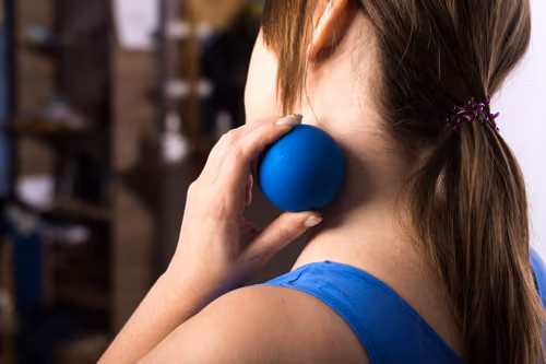 Using a massage ball on the neck for self myofascial release to relieve muscle tension