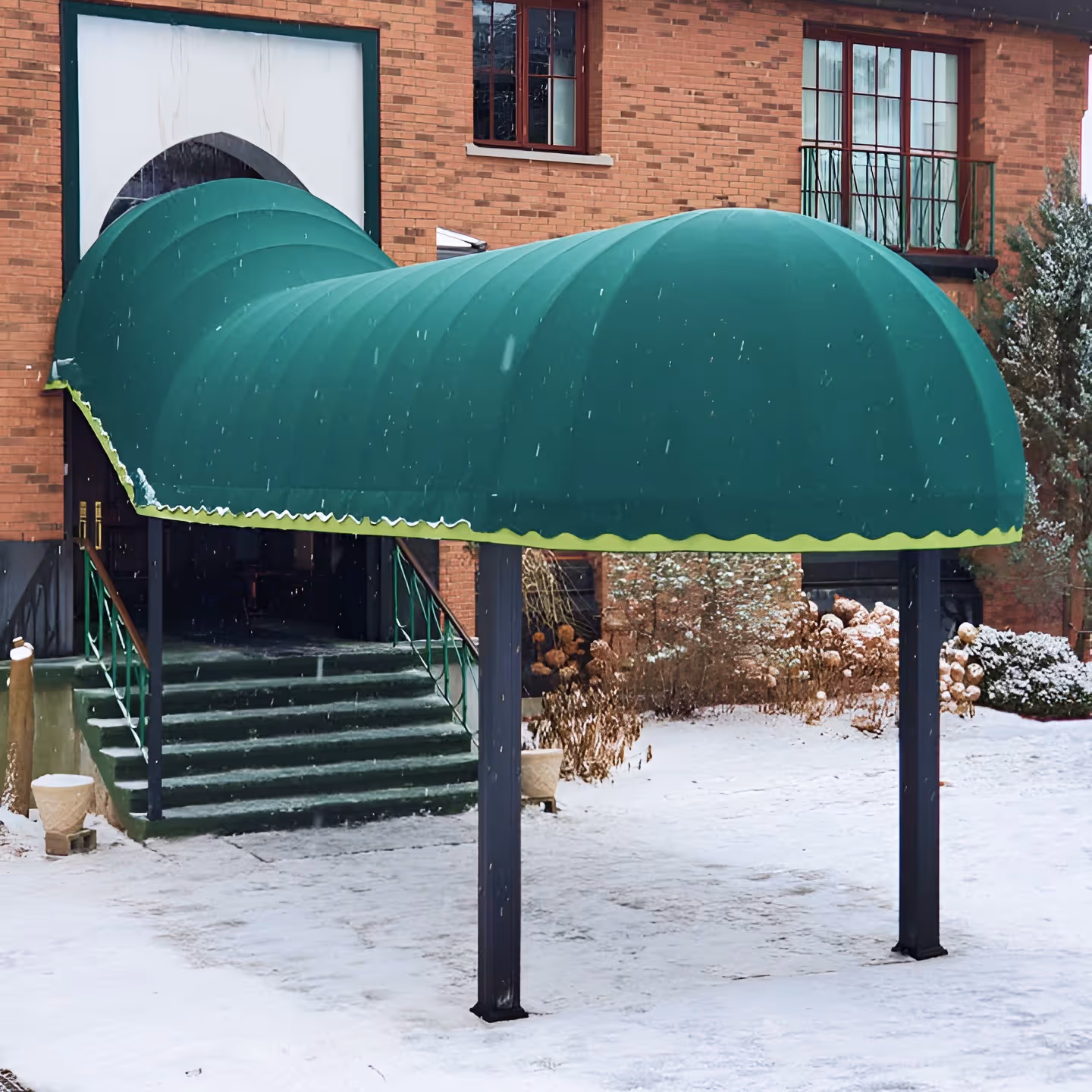 Stairs leading from an entrance onto a walkway, both covered by a single green awning with a domed front.
