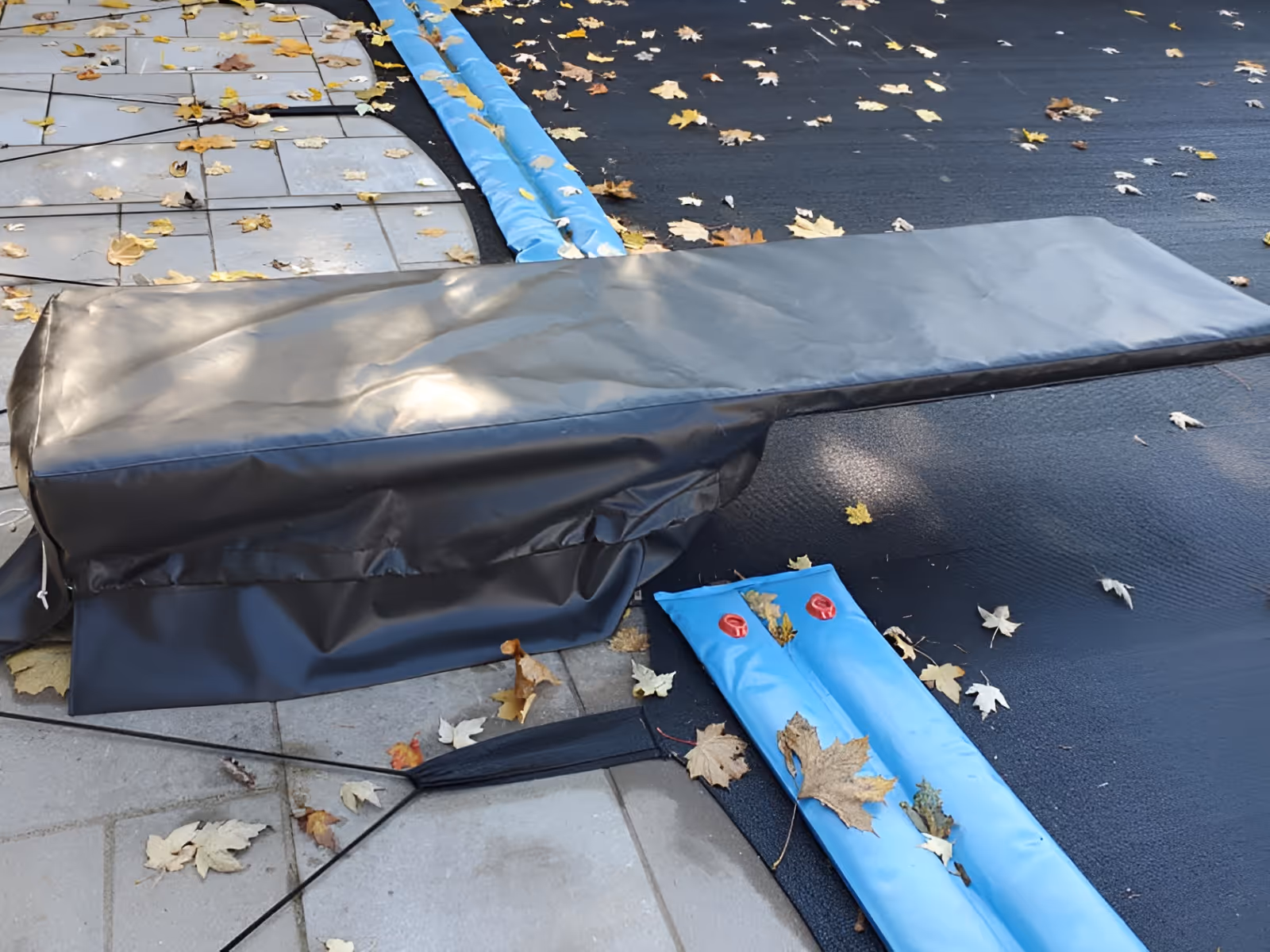 Diving board cover made of black vinyl fabric.