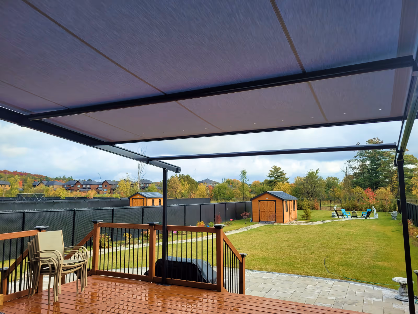View under a Pergolino awning with its grey fabric extended about three-quarters of the way out.