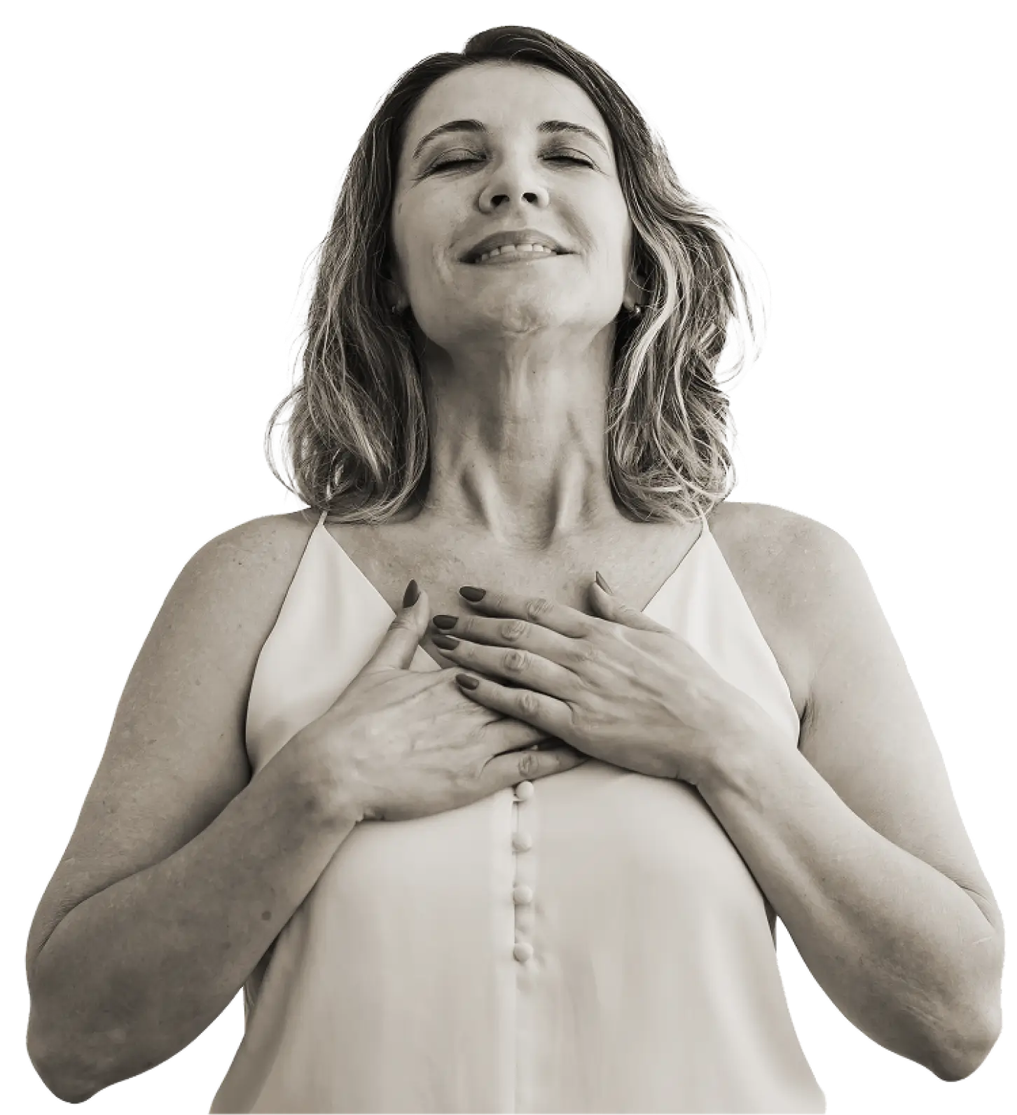 Middle-aged woman with closed eyes smiling gently, hands placed over her chest, wearing a sleeveless top.