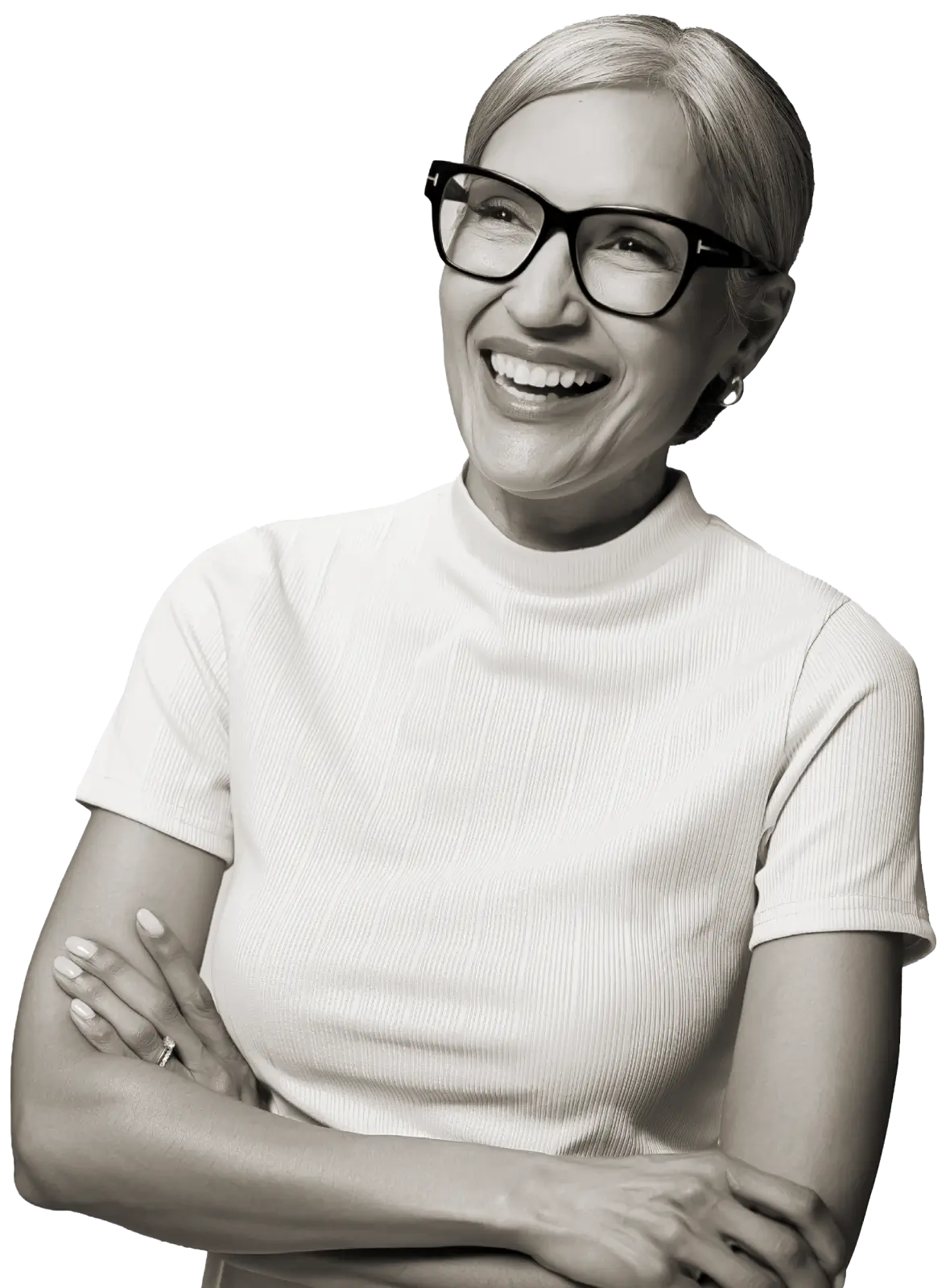 Confident middle-aged woman with glasses standing with arms crossed wearing a button-up shirt and jeans.