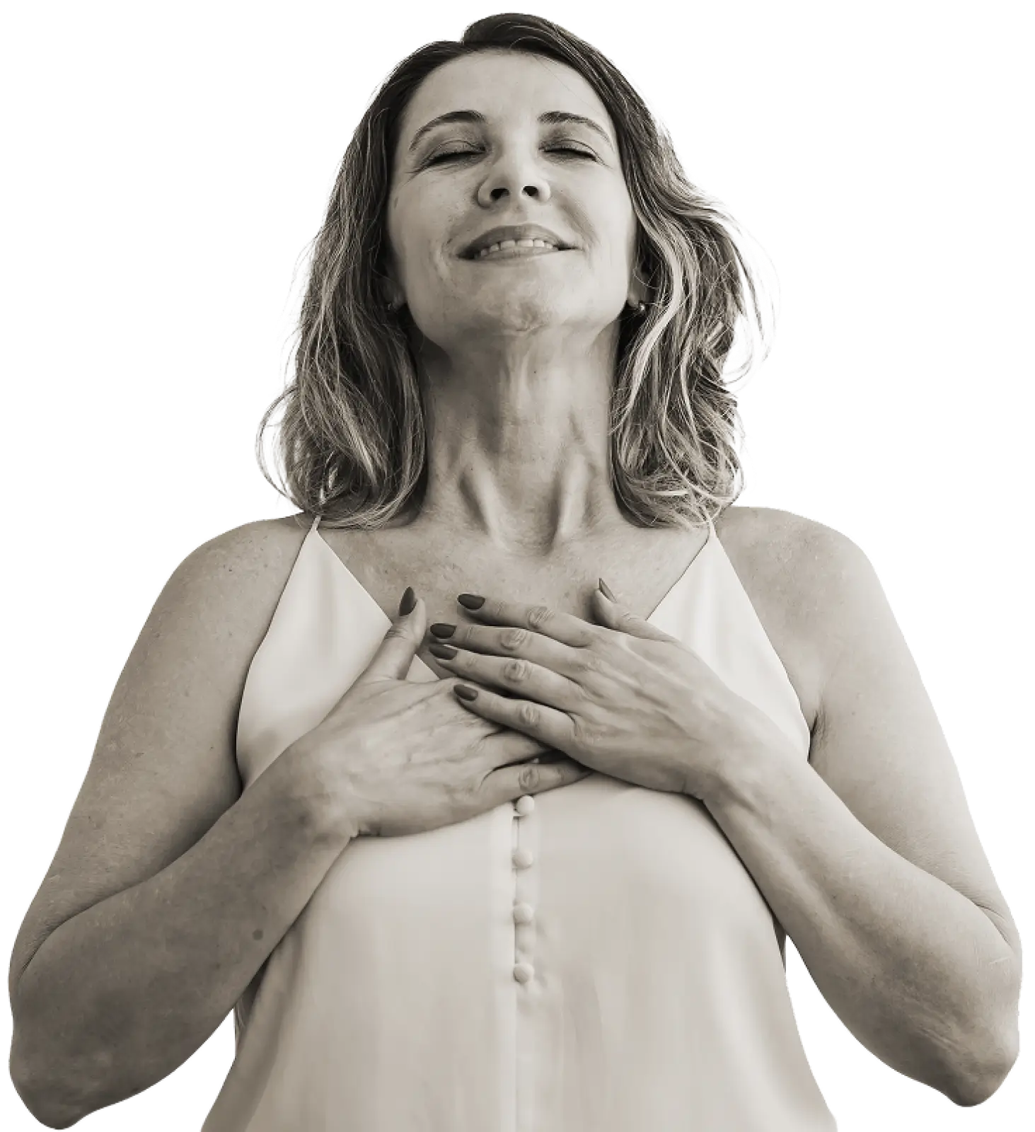 Middle-aged woman with closed eyes and a slight smile, holding her hands over her chest in a calm, content gesture.