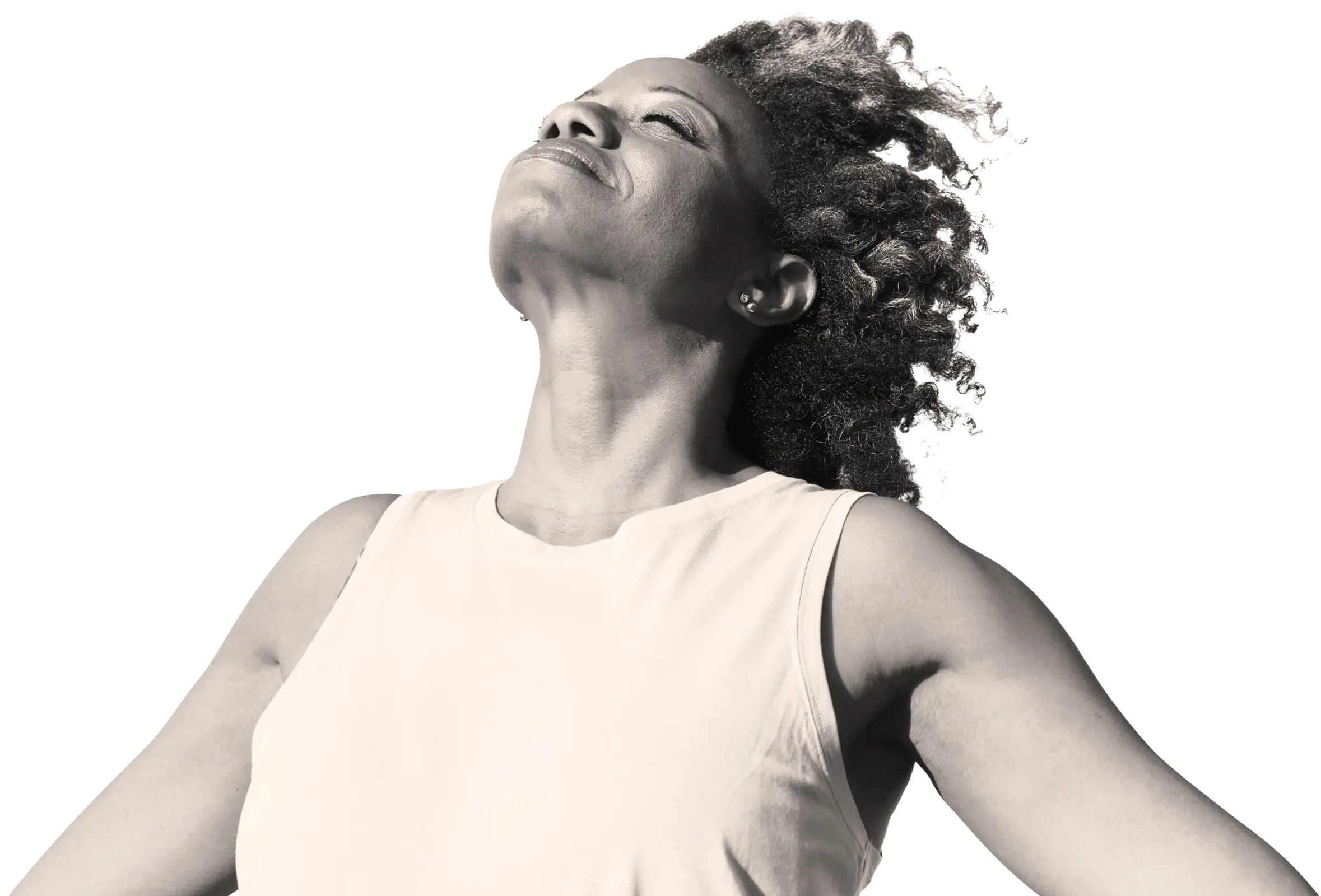 Portrait of a woman with curly hair wearing a sleeveless top, looking upward with a serene expression.