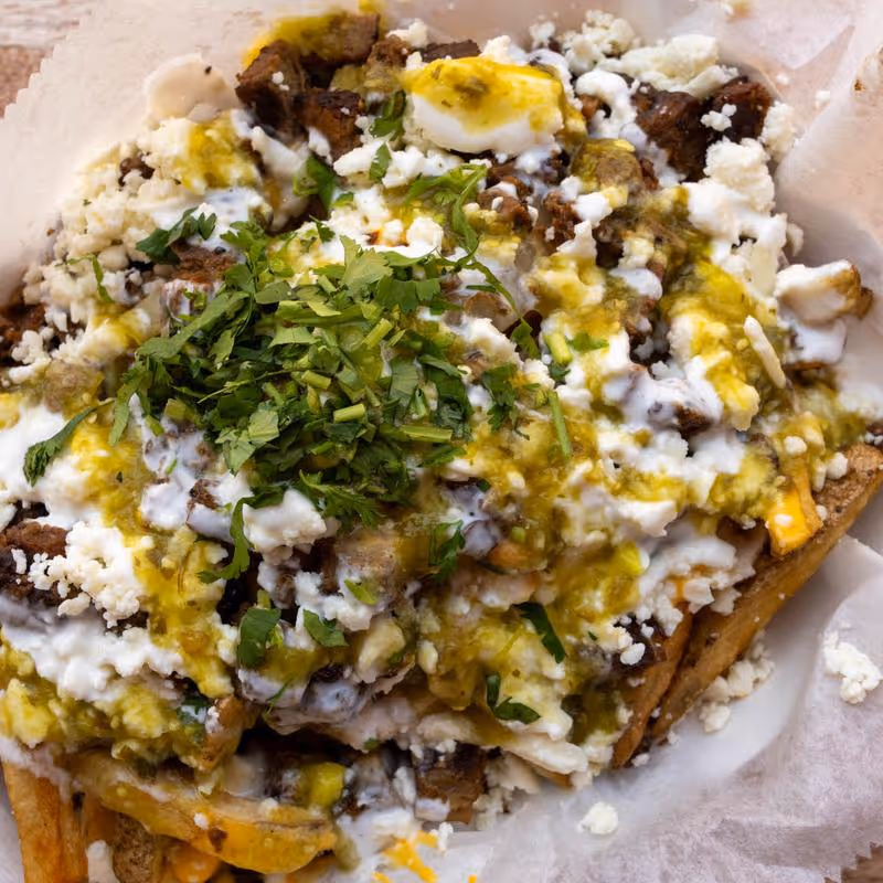 A plate of food with a green vegetable on top.