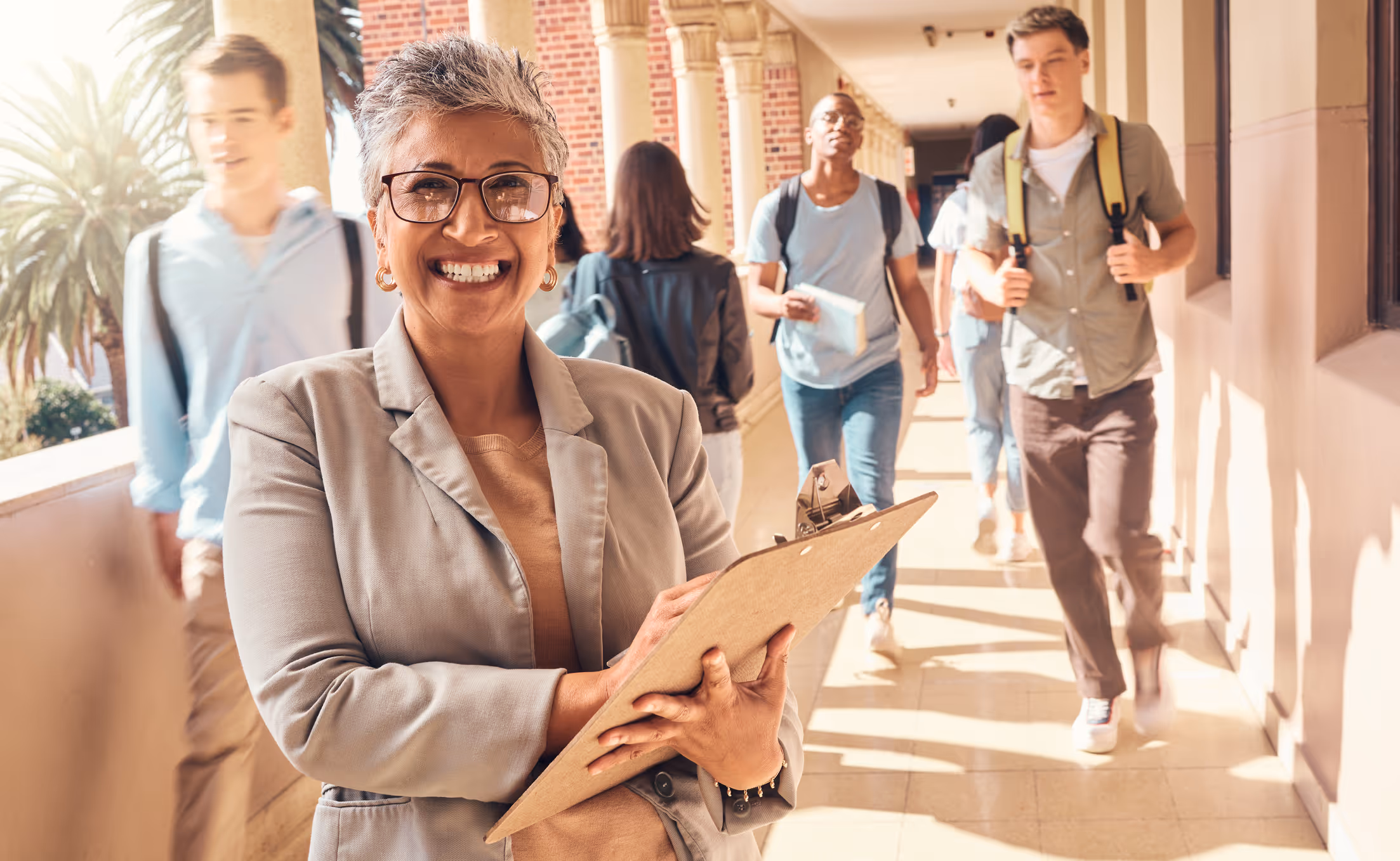 iStock 2156006482 High TeacherSmilingInHallway