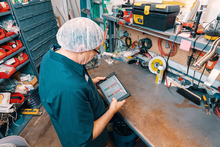 Employee hold iPad with Redzone Reliability module