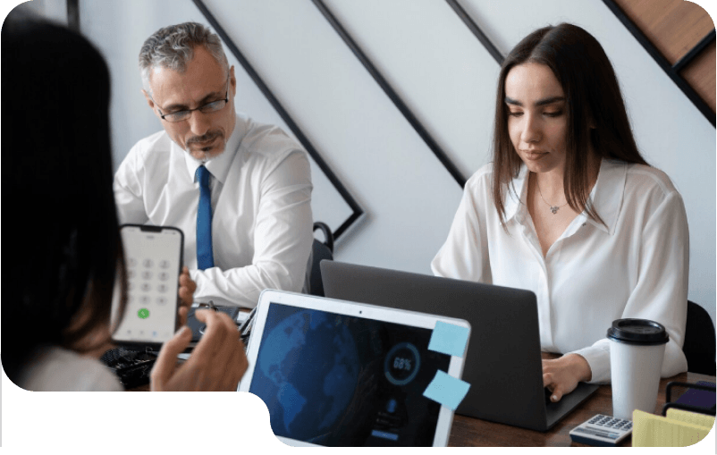 Man analyzing candidate profiles and skill assessment charts on a desktop monitor in an office.