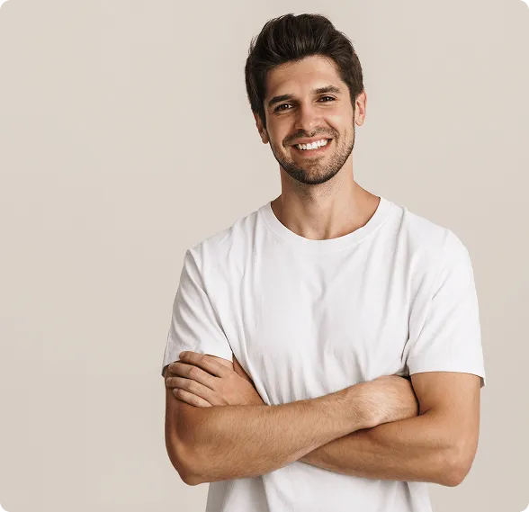 Dentist holding a dental shade guide near a smiling woman's teeth to match tooth color.