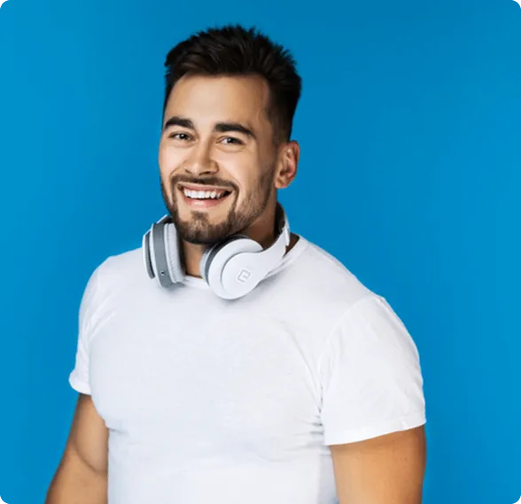 Smiling woman sitting in a dental chair giving a thumbs-up with a dental bib.