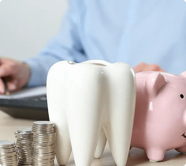 Smiling man sitting in a dental chair giving a thumbs-up in a bright dental office.