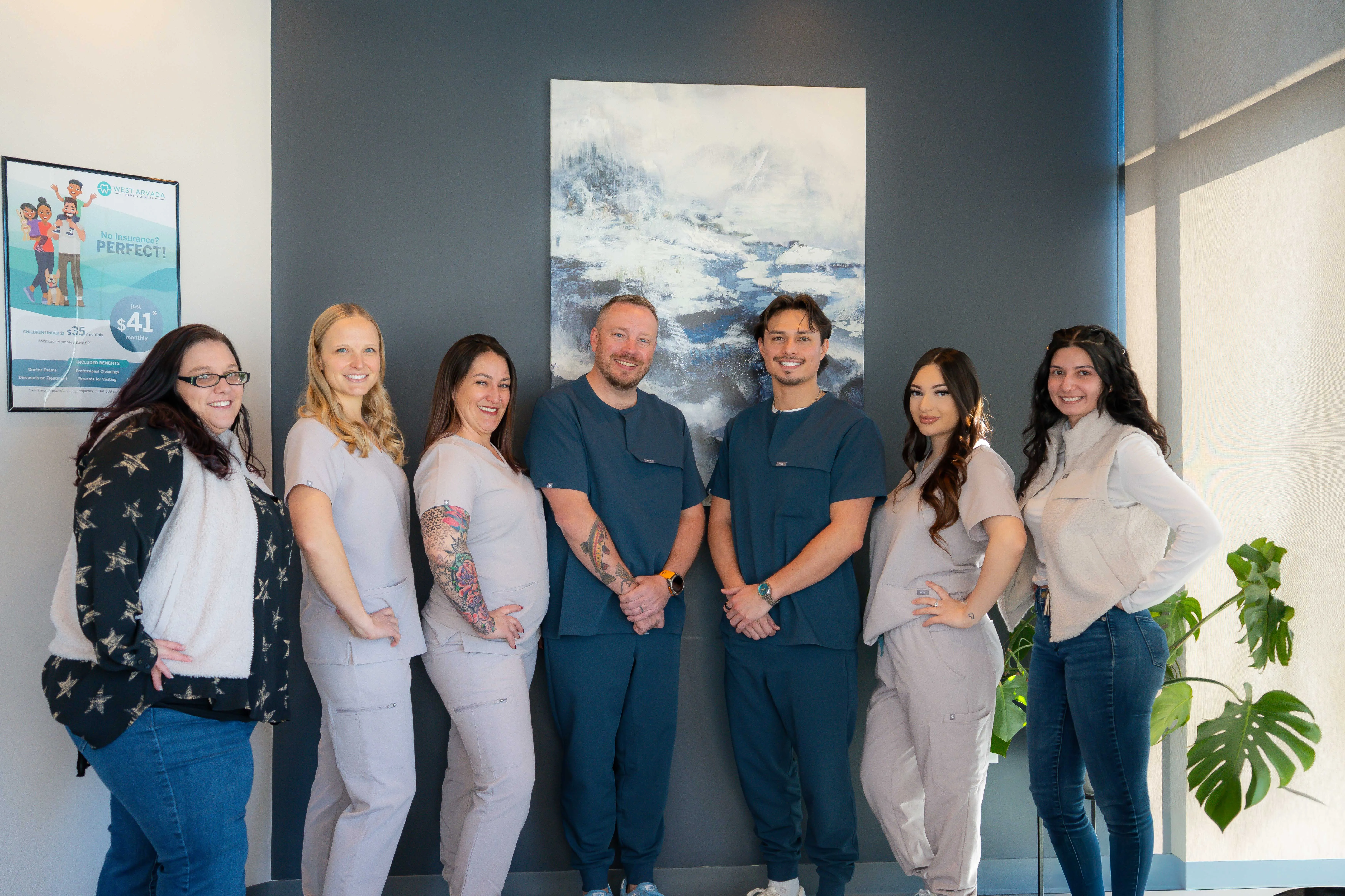 West Arvada Modern office reception area with a marble front desk, two computer monitors, large windows, and pendant lights.