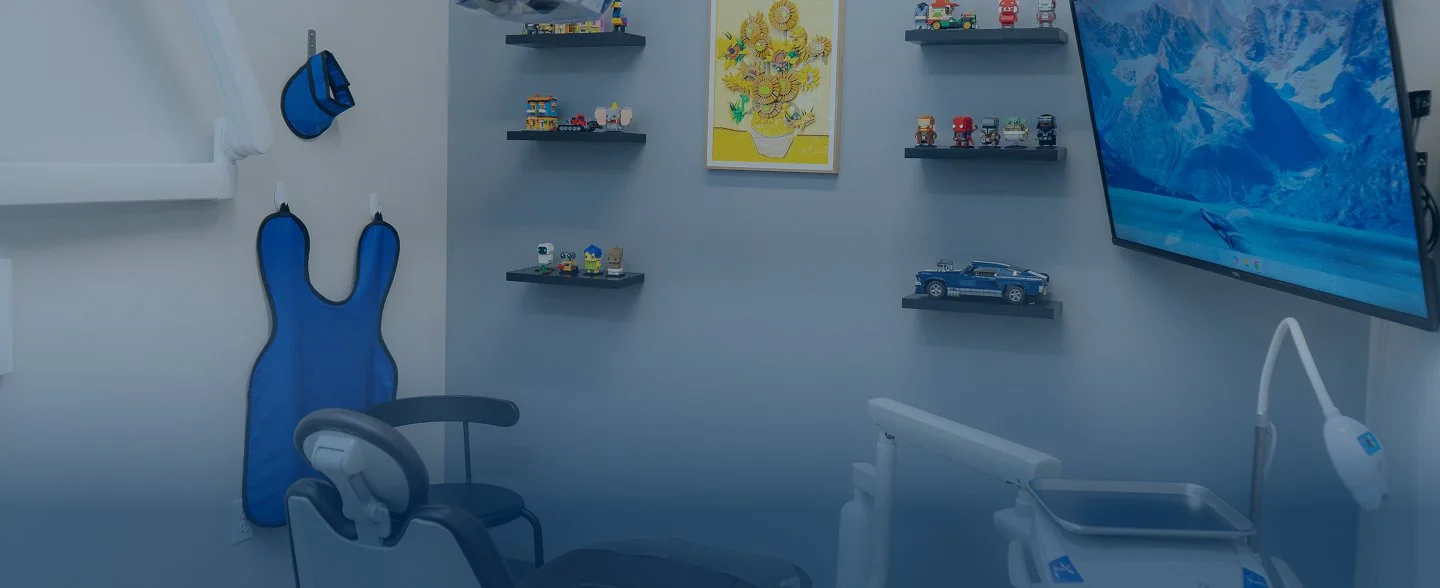 Modern reception desk with marble countertop, two computer monitors, pendant lights, and large windows showing exterior building.