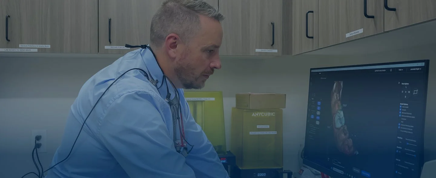 Modern reception desk with marble countertop, two computer monitors, pendant lights, and large windows showing exterior building.