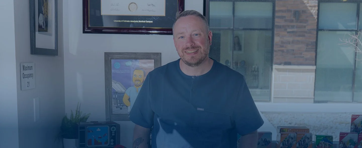 Modern reception desk with marble countertop, two computer monitors, pendant lights, and large windows showing exterior building.