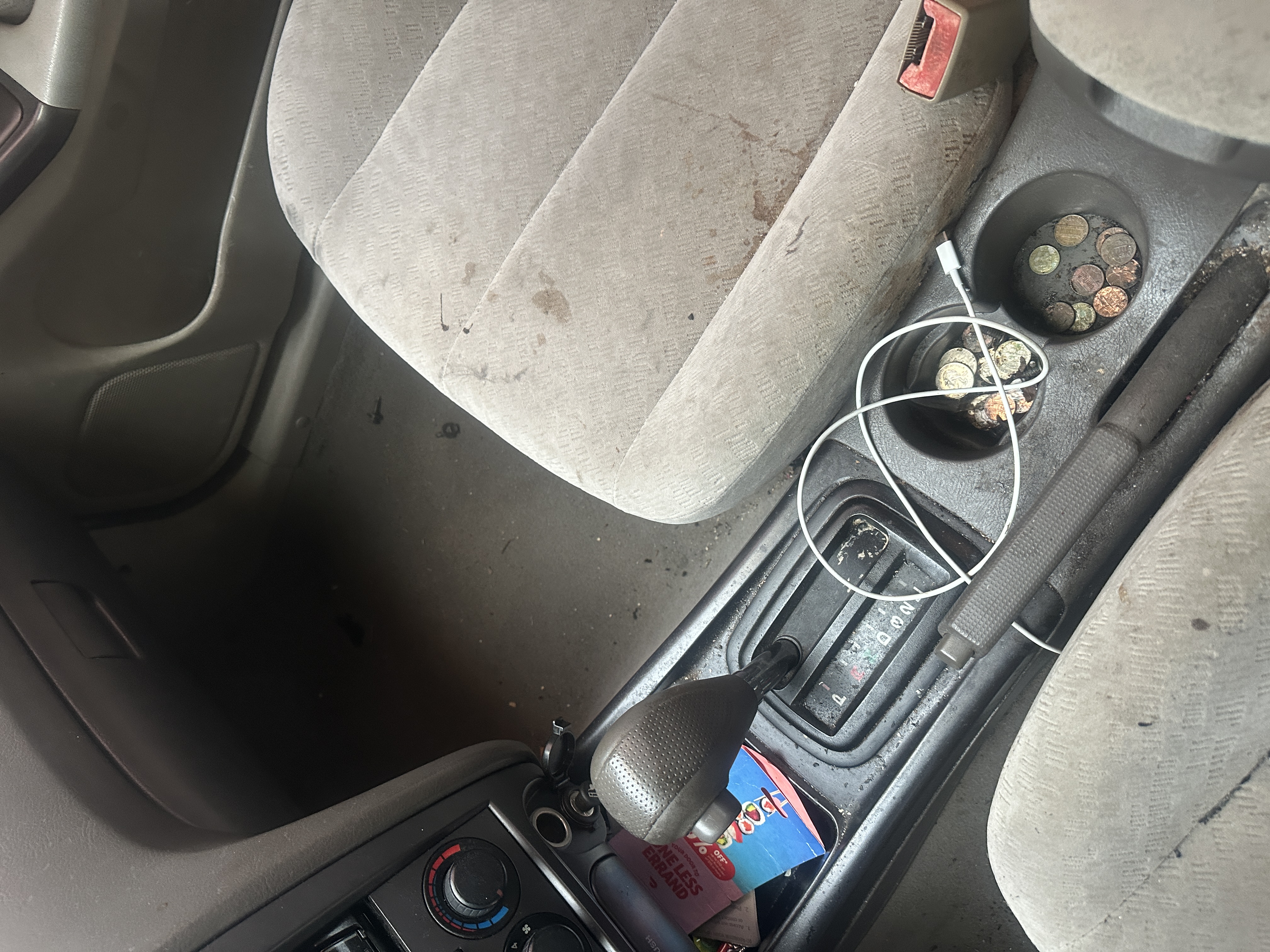 Dirty car interior before detailing in Prince George VA showing seats, center console, and floor mats