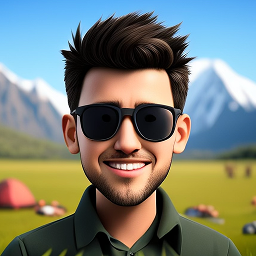 Smiling young man with dark hair wearing black sunglasses and a dark shirt in a mountainous outdoor setting.