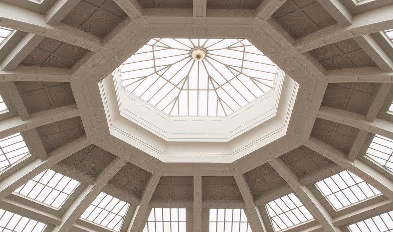 Octagonal skylight with multiple window panes in a beige ceiling structure.