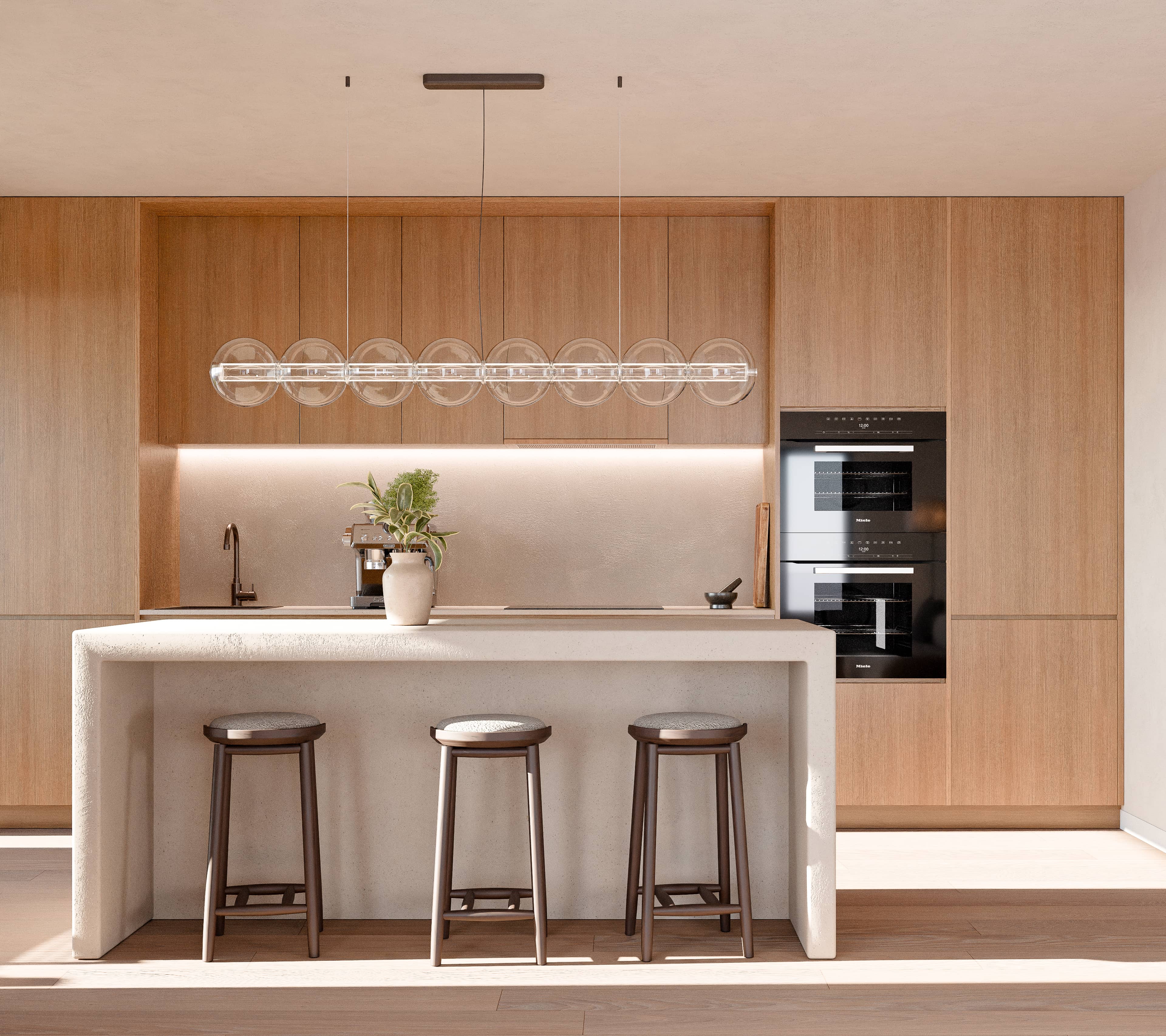 Cuisine moderne avec des armoires en bois, un grand îlot en pierre avec trois tabourets, un luminaire suspendu avec des sphères en verre et des fours noirs encastrés.