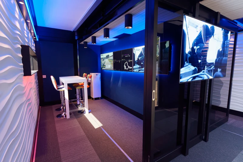 Inside an Expandable broadcast trailer's advanced control room, equipped with an array of monitors and broadcasting equipment by NEP, showcasing live feeds and editing software in action