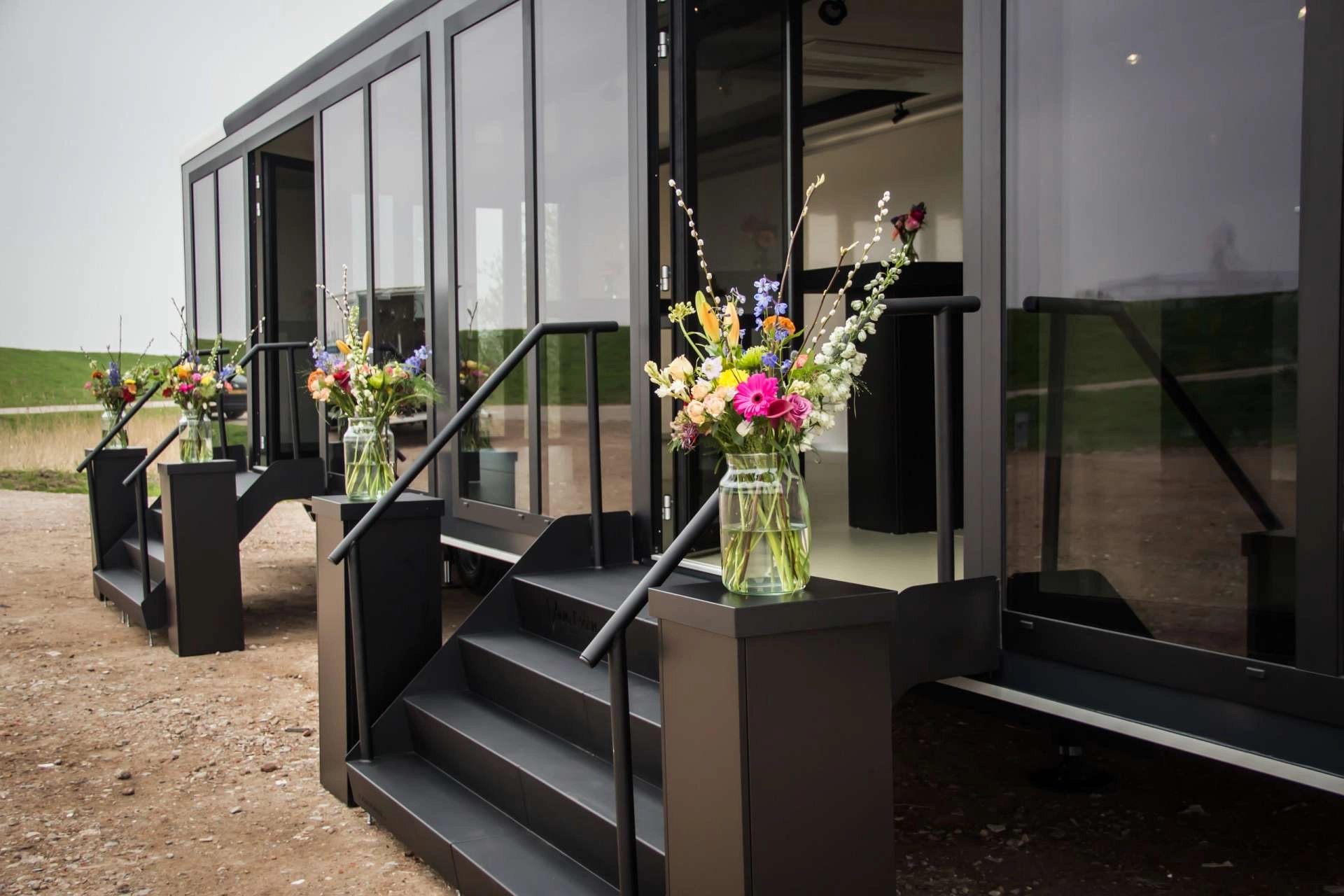 Welcoming entrance of Van Essen's Expandable trailer adorned with vibrant flower arrangements, showcasing their attention to detail and hospitality.