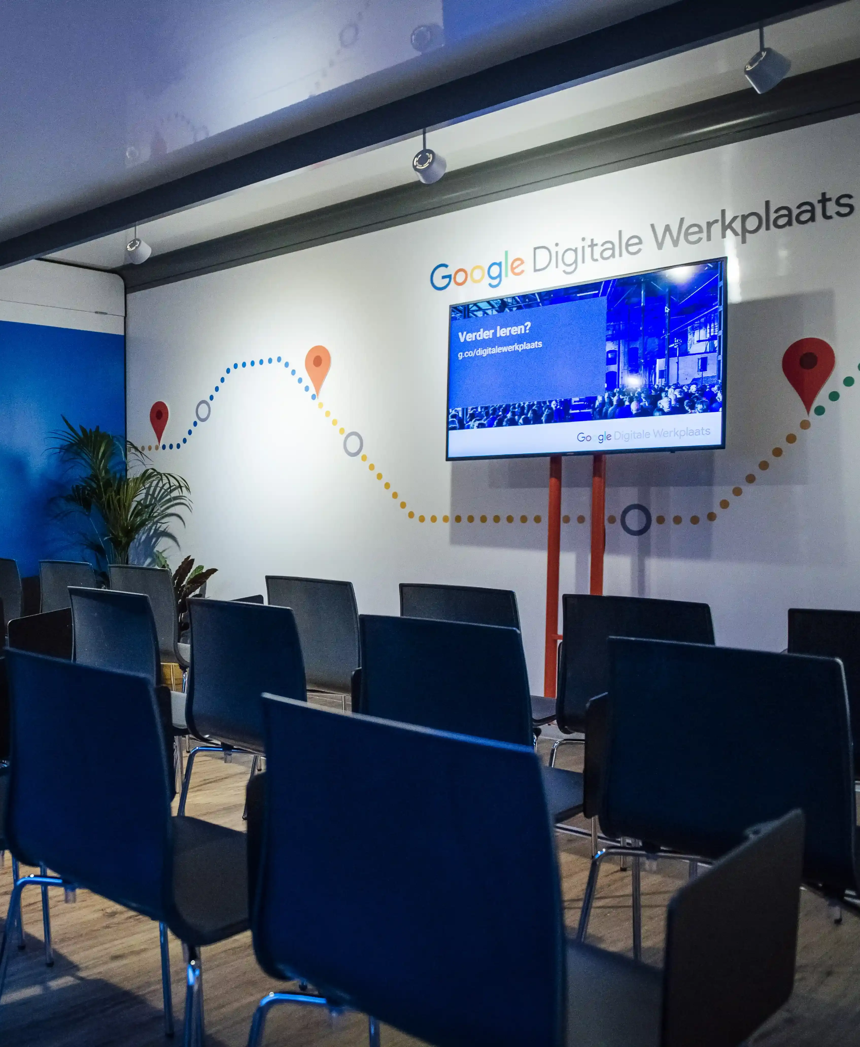 Inside the advertising trailer, a Google Digital Workshop is set up with rows of chairs facing a presentation screen, ready for an educational session.
