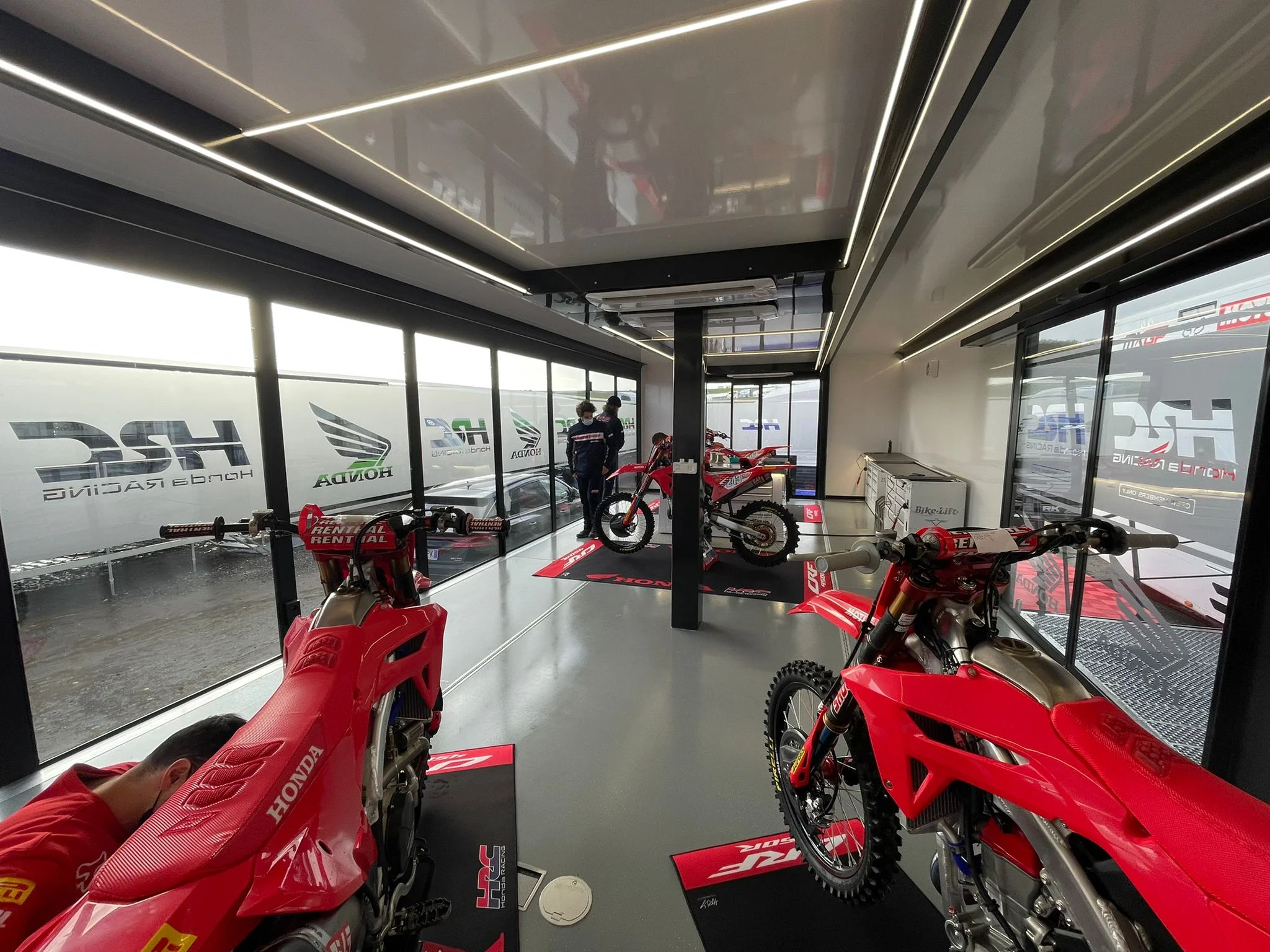 Inside Expandable Motorcycle workshop trailer with Honda motorcycles
