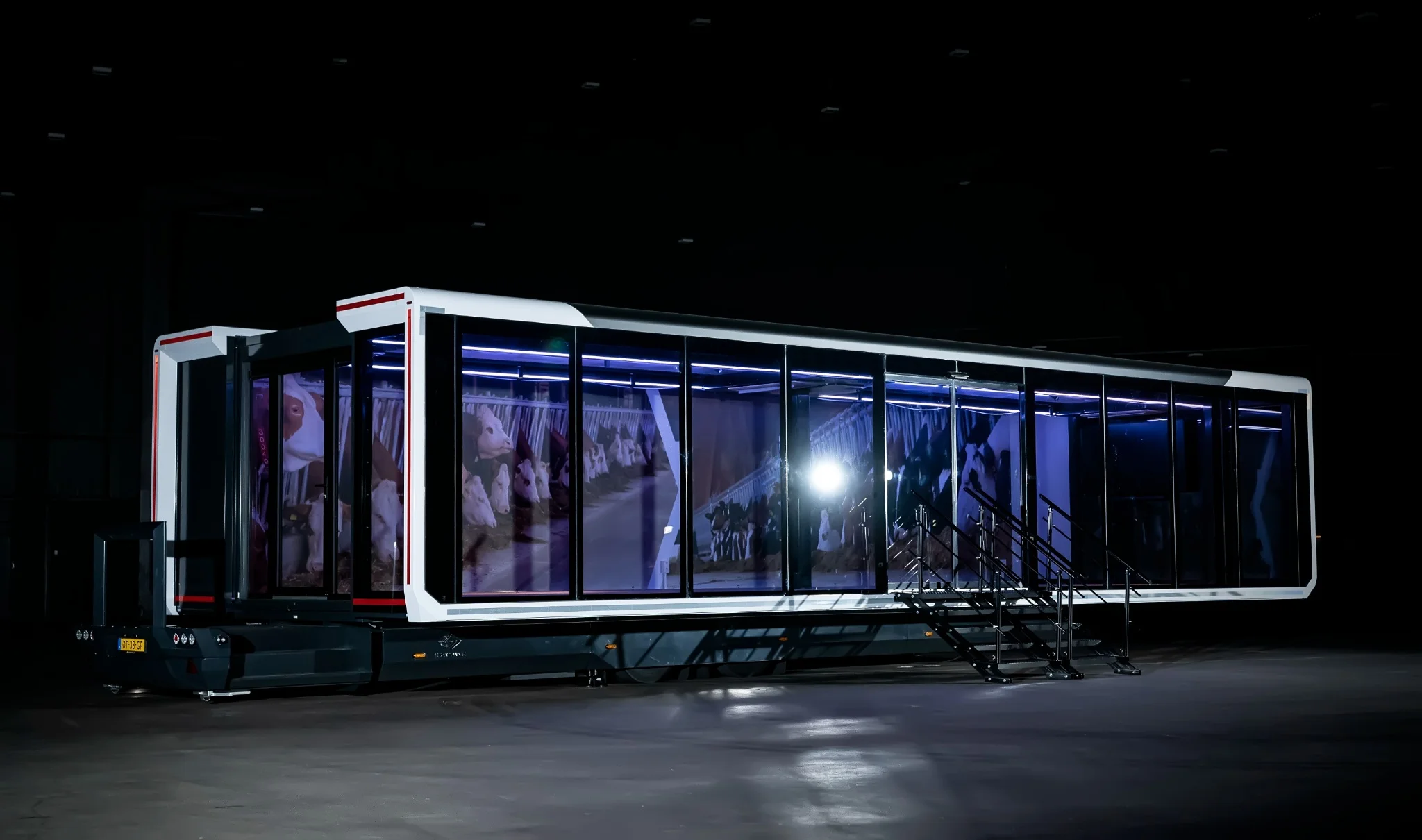 An Expandable Exhibition trailer with the Lely branding on it. Inside there is a farming background on the inside, which refers to the background of Lely