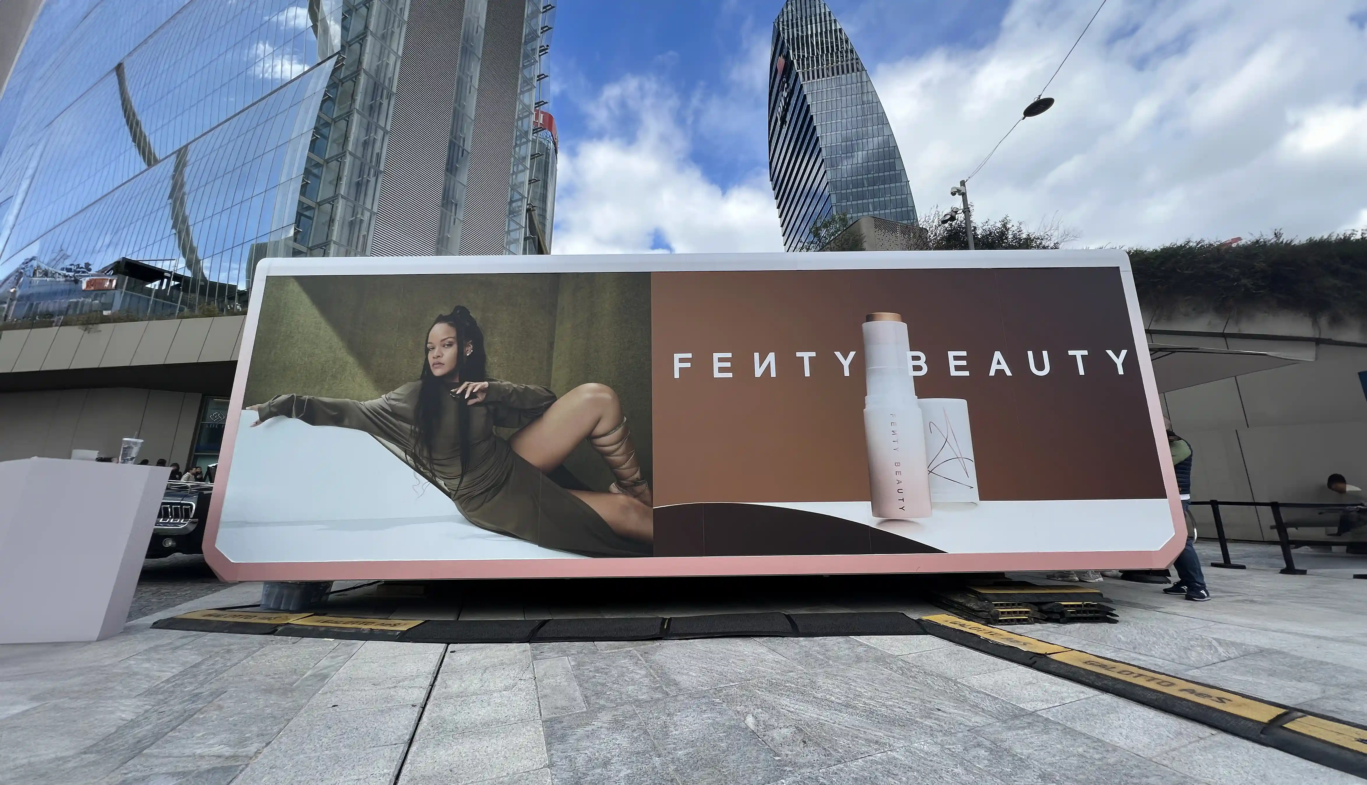 A large roadshow trailer emblazoned witht Rihanna and her products.