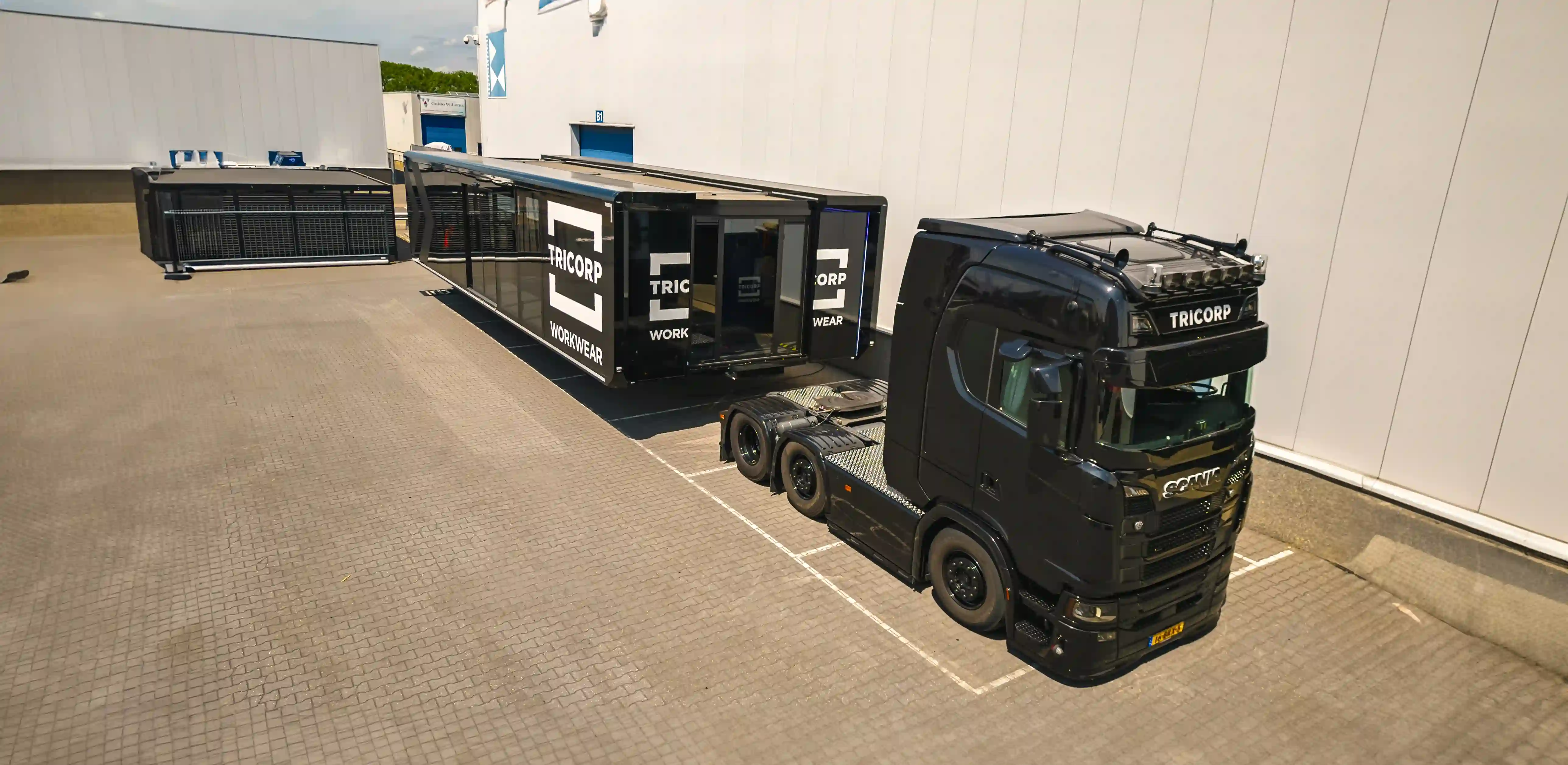 Mobile fitting room trailer attached to a truck, ready for transport to a new location, illustrating mobility and convenience.