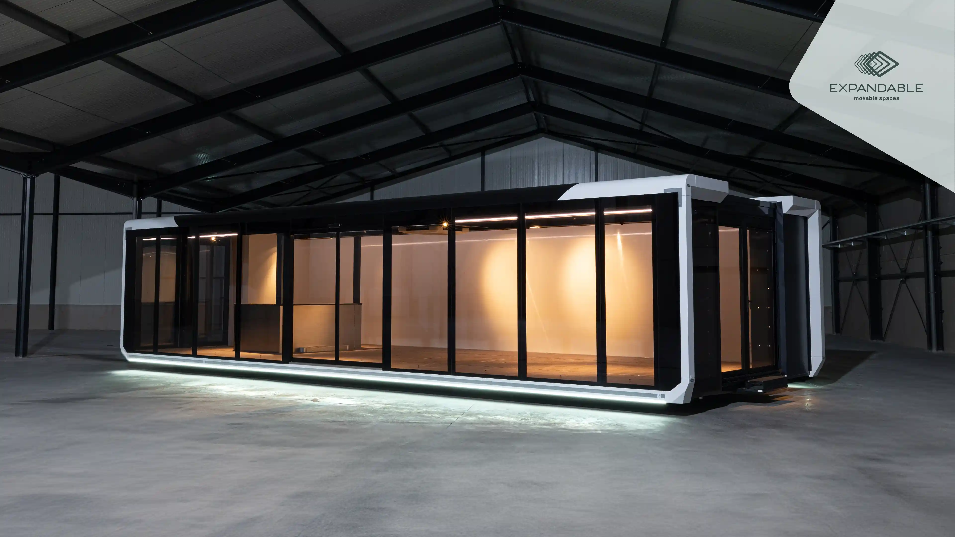 Side view of the Expandable Hybrid unit partially expanded with lights illuminating the interior.