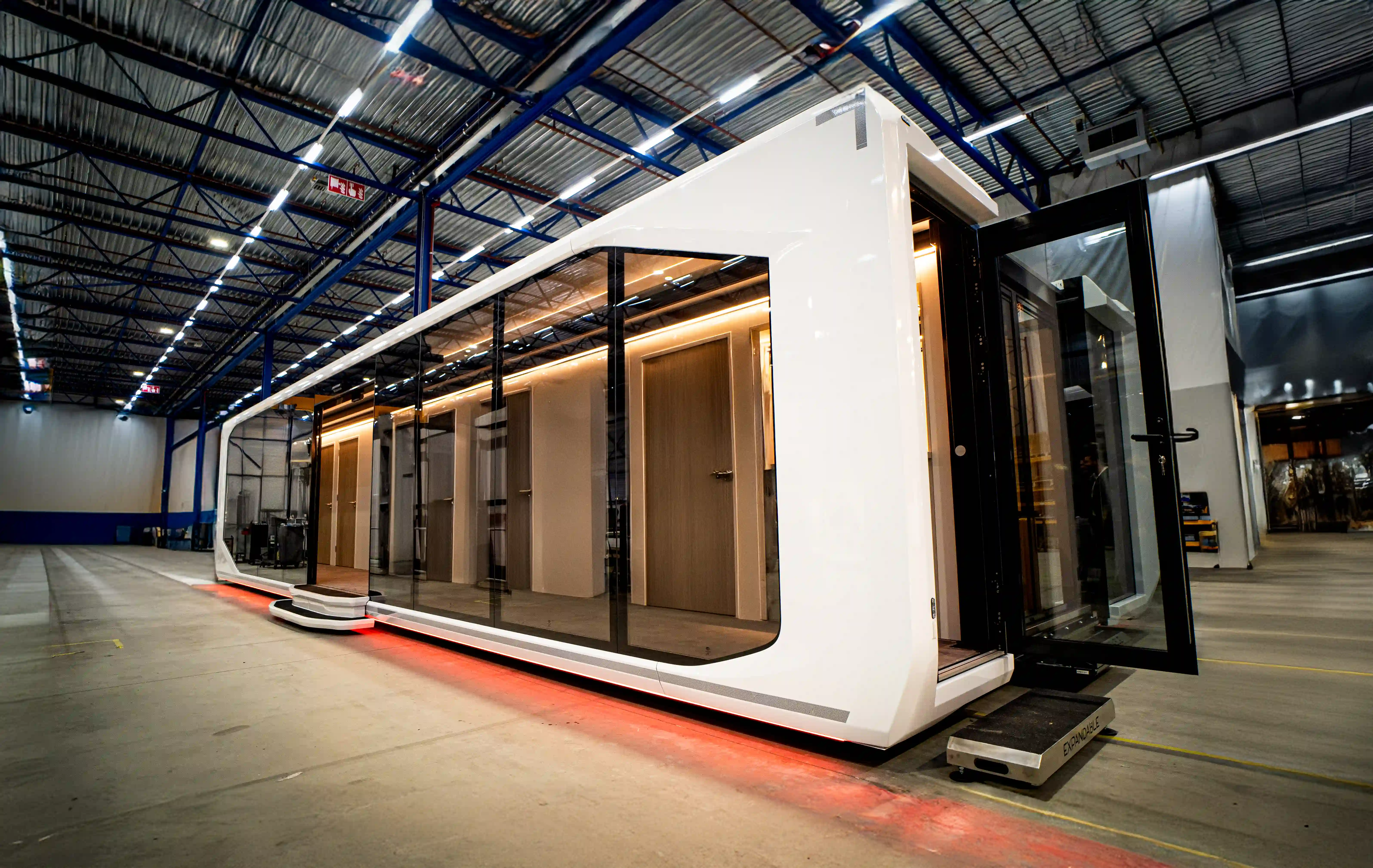 Expandable Touchdown Unit in a warehouse, showcasing its sleek design and state-of-the-art mobile health clinic capabilities