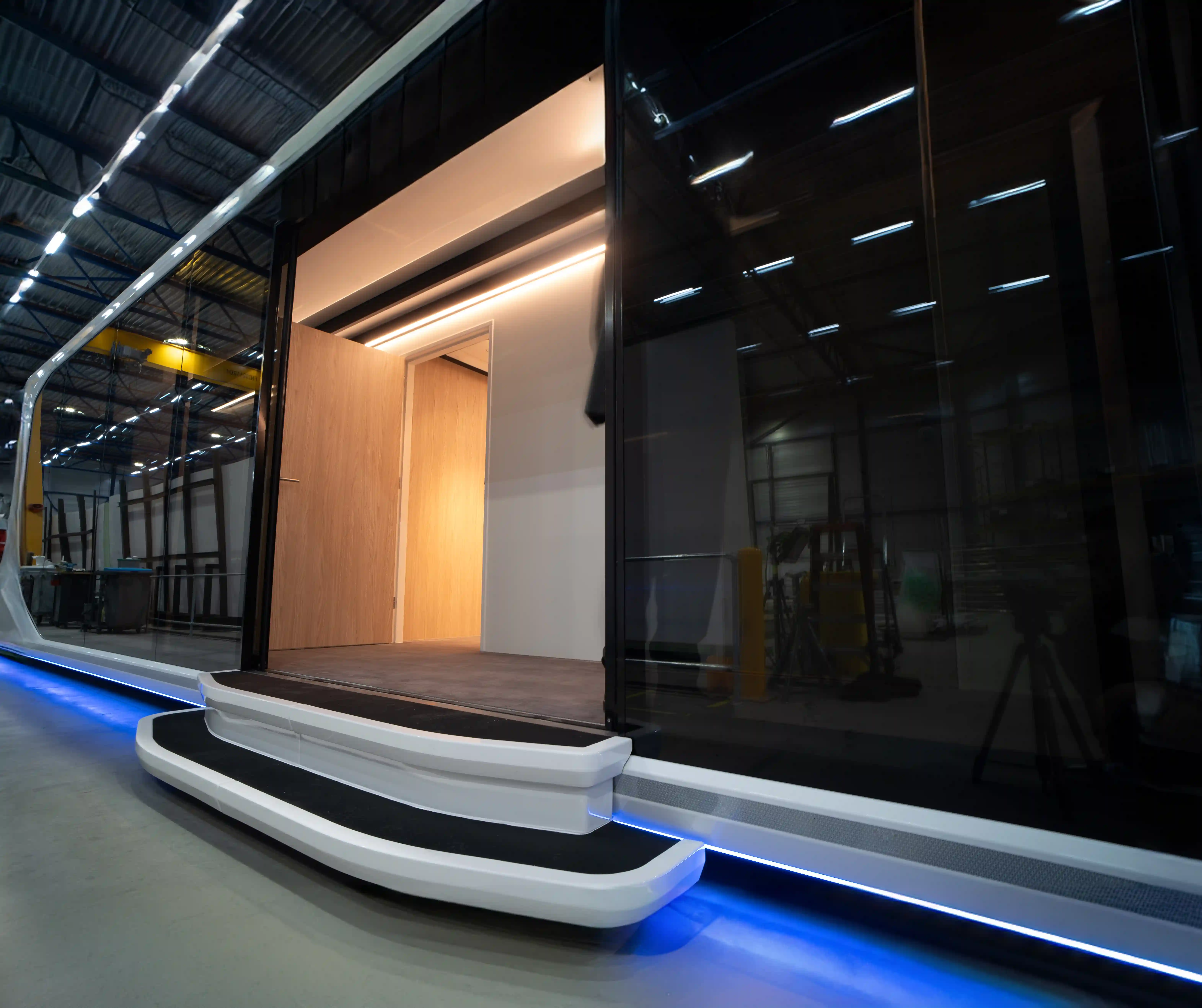 Entrance of the Expandable Touchdown Unit with illuminated steps and a modern design, showcasing its mobile health clinic capabilities.