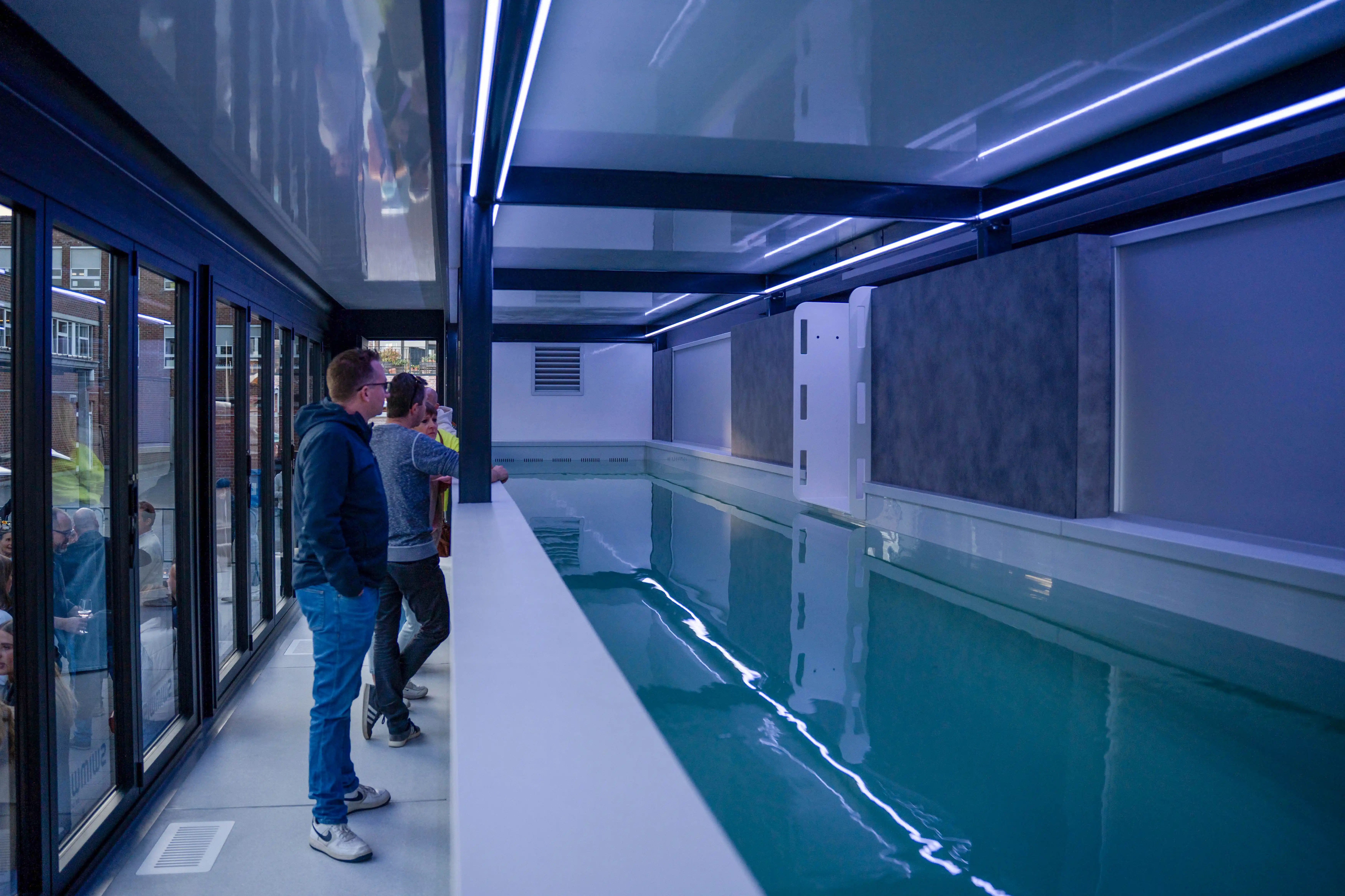 Modular pool trailer with hydraulic legs in action, stabilizing the setup on uneven ground.