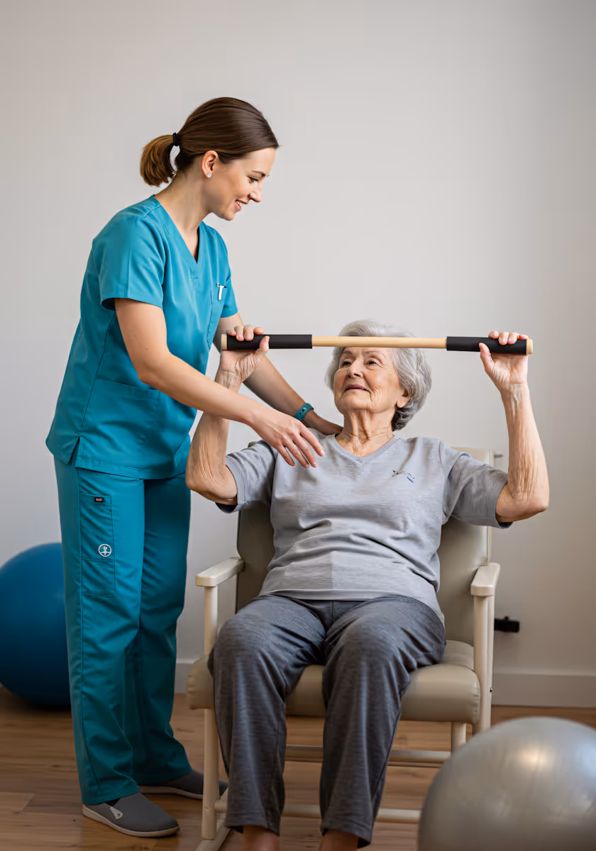 Physical therapist assisting elderly woman seated in chair with arm exercise using wooden stick.