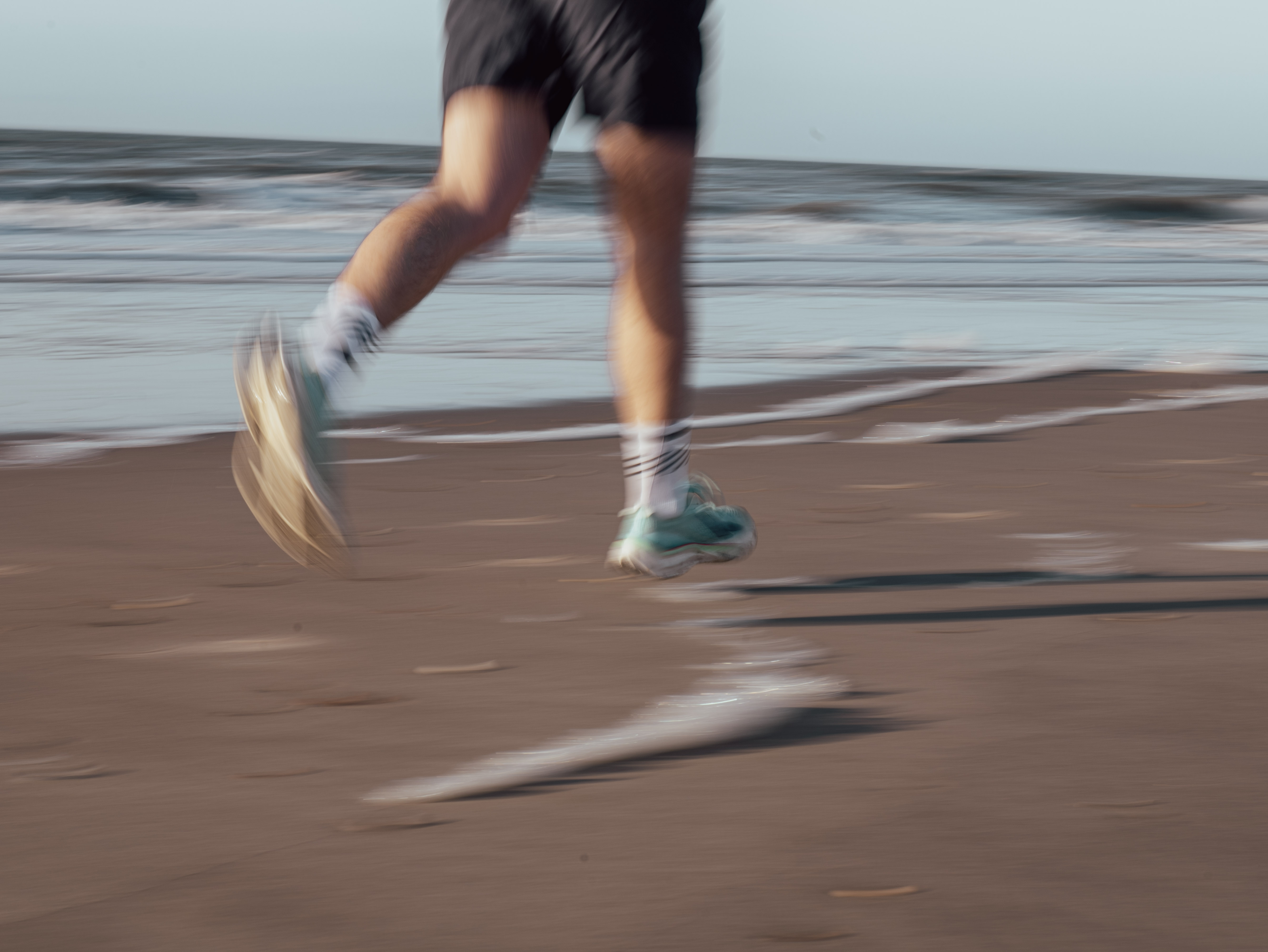 Dynamic picture of feet on the beach whilst running | SCIPIO