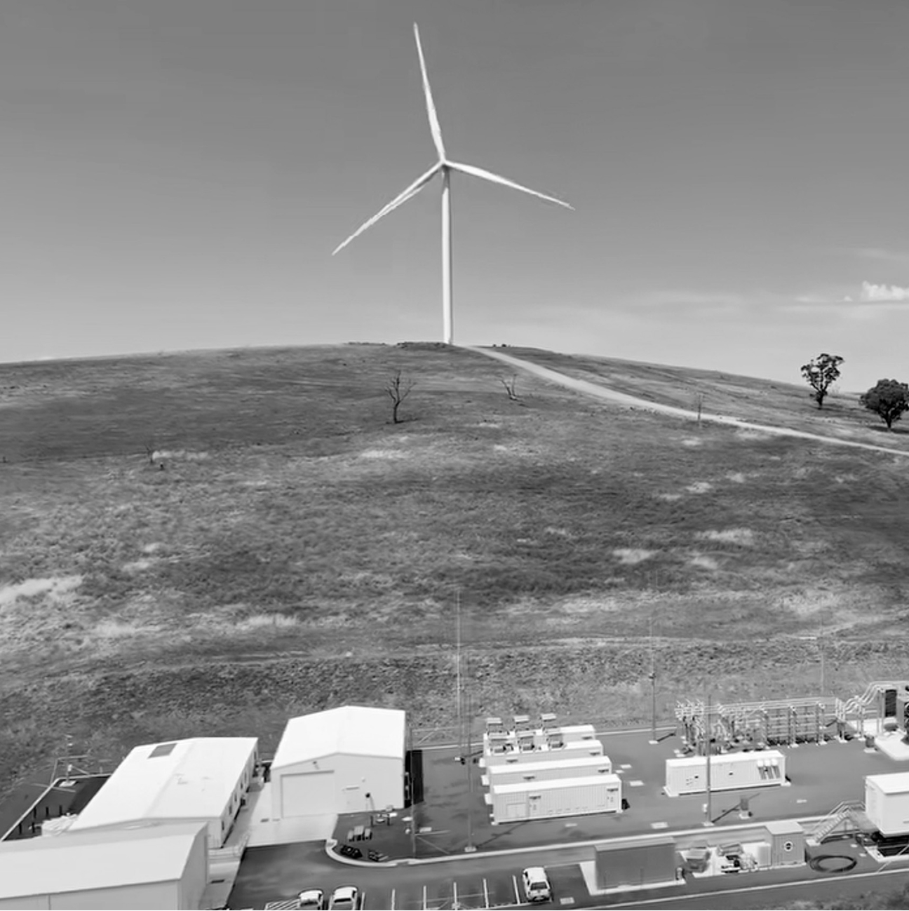 Essential Energy electrical substation beneath a wind turbine in regional Australia.
