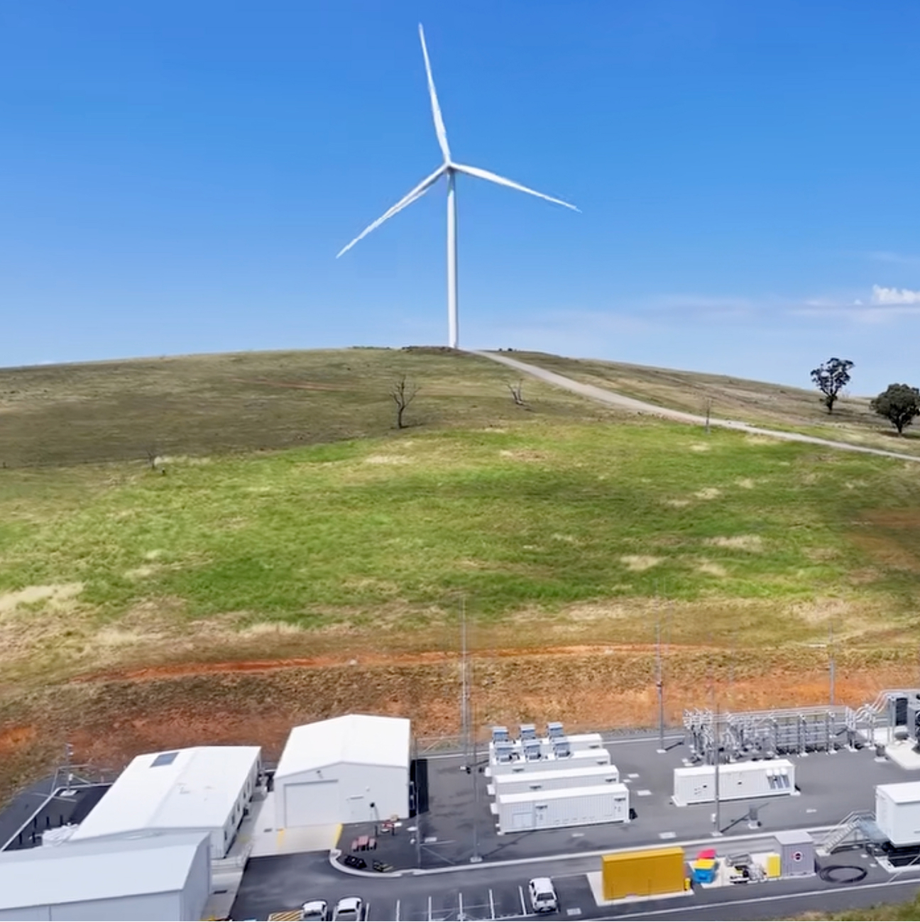 Essential Energy electrical substation beneath a wind turbine in regional Australia.