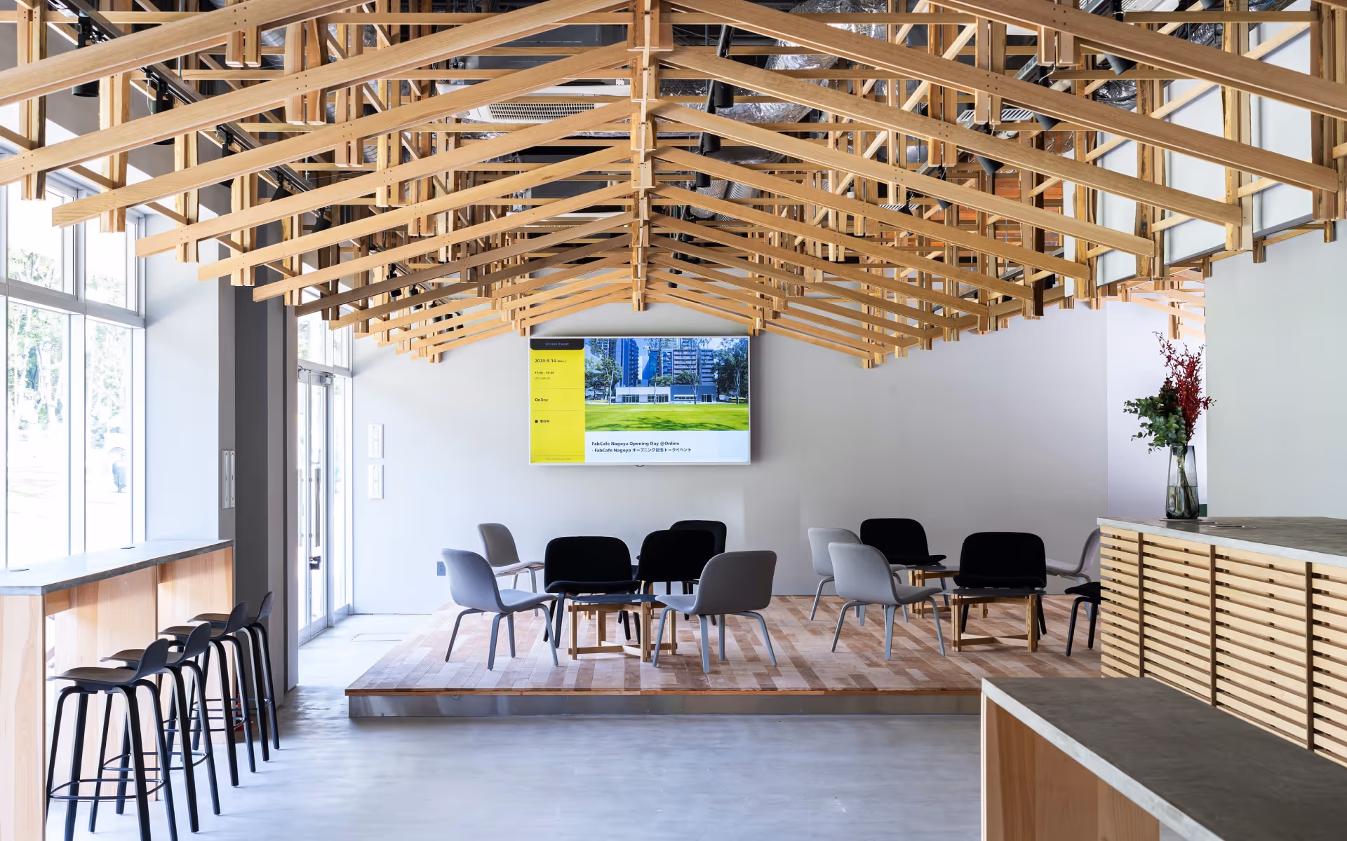 Bright interior of FabCafe Nagoya with a distinctive wooden ceiling, open seating area, and calm café atmosphere.