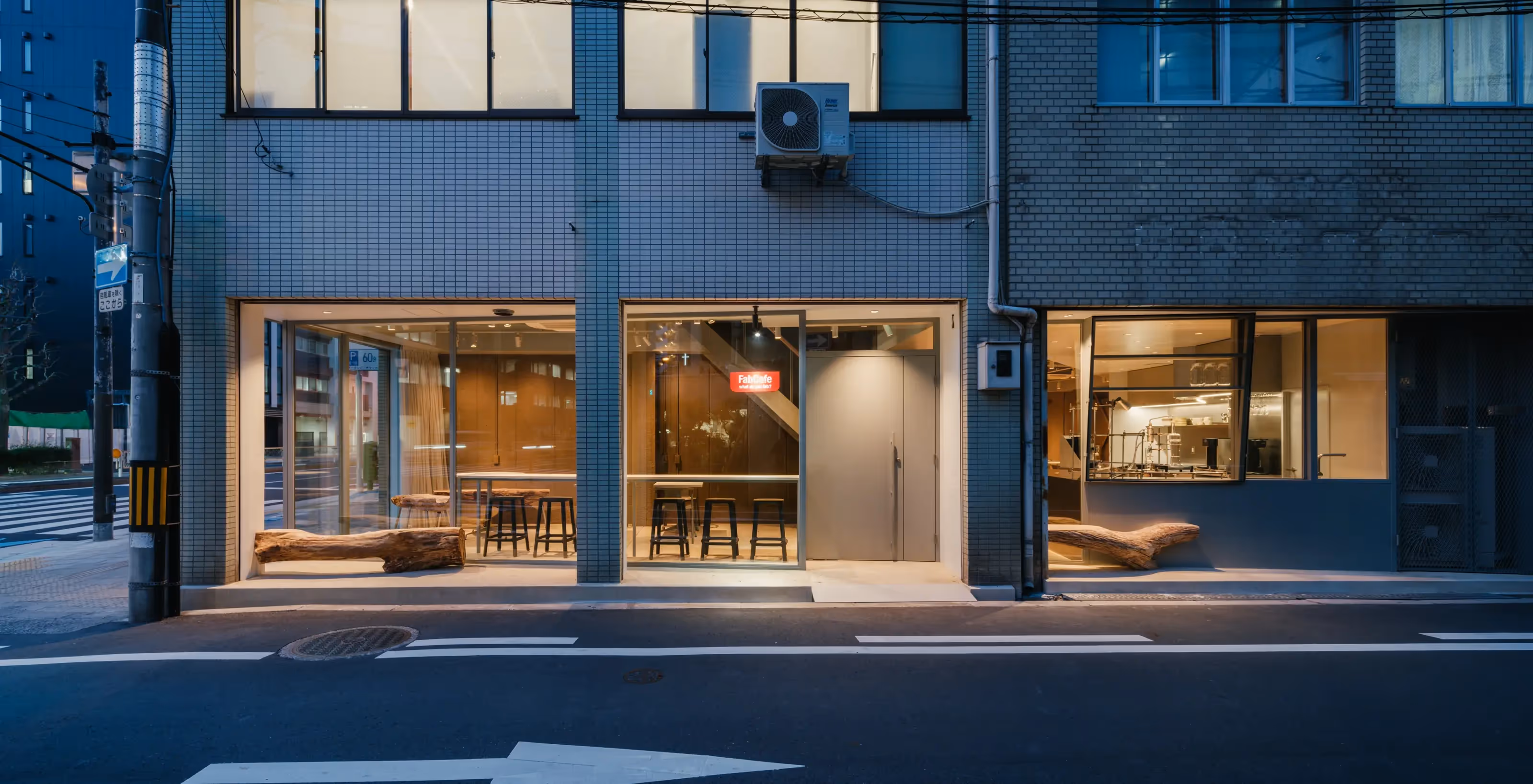 Outside of Fabcafe Osaka with two people drinking its coffee just in front of it