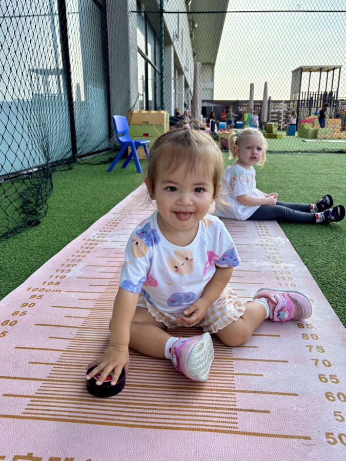 A toddler playing quietly on a soft floor mat in a calm corner.