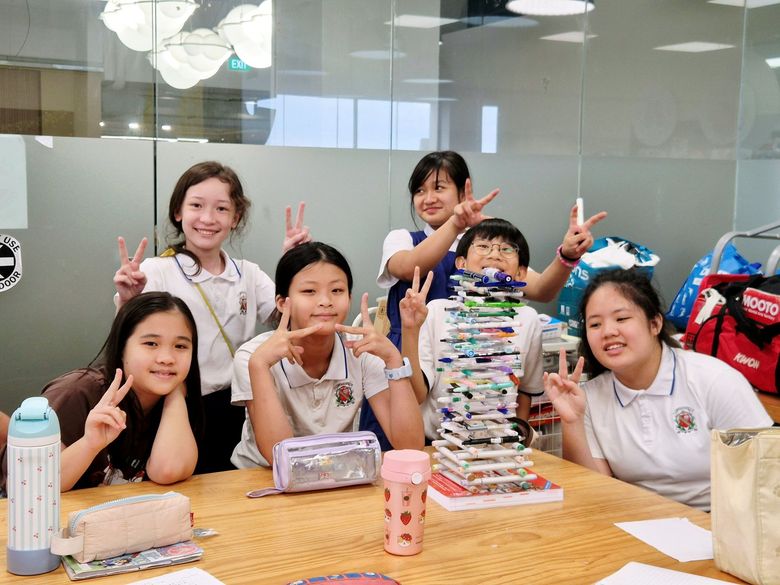 Children working at a project table in the bright studio